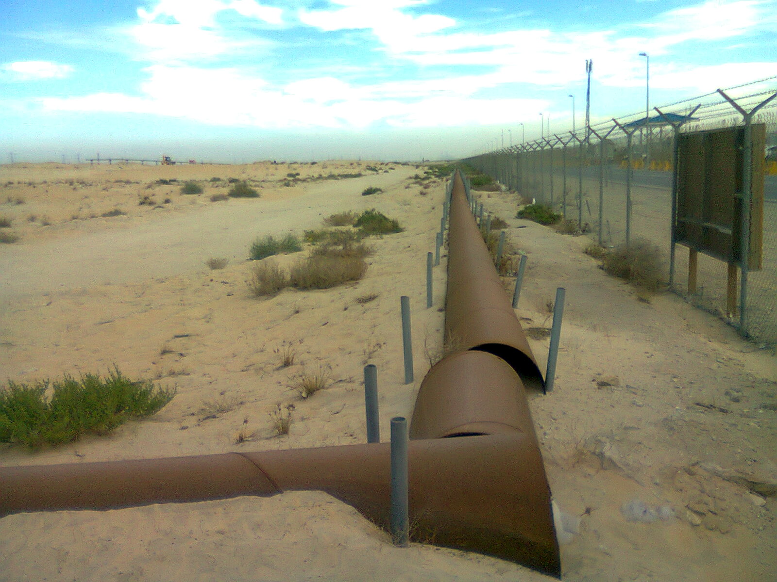 Oil pipelines near Jubail, Saudi Arabia (archive) Archive photograph of oil pipelines crossing the desert near Jubail, Saudi Arabia