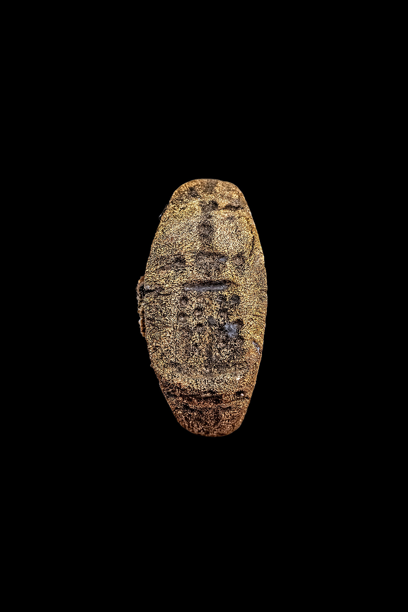 A close view of a bronze ring engraved with a representation of the Lighthouse of Alexandria