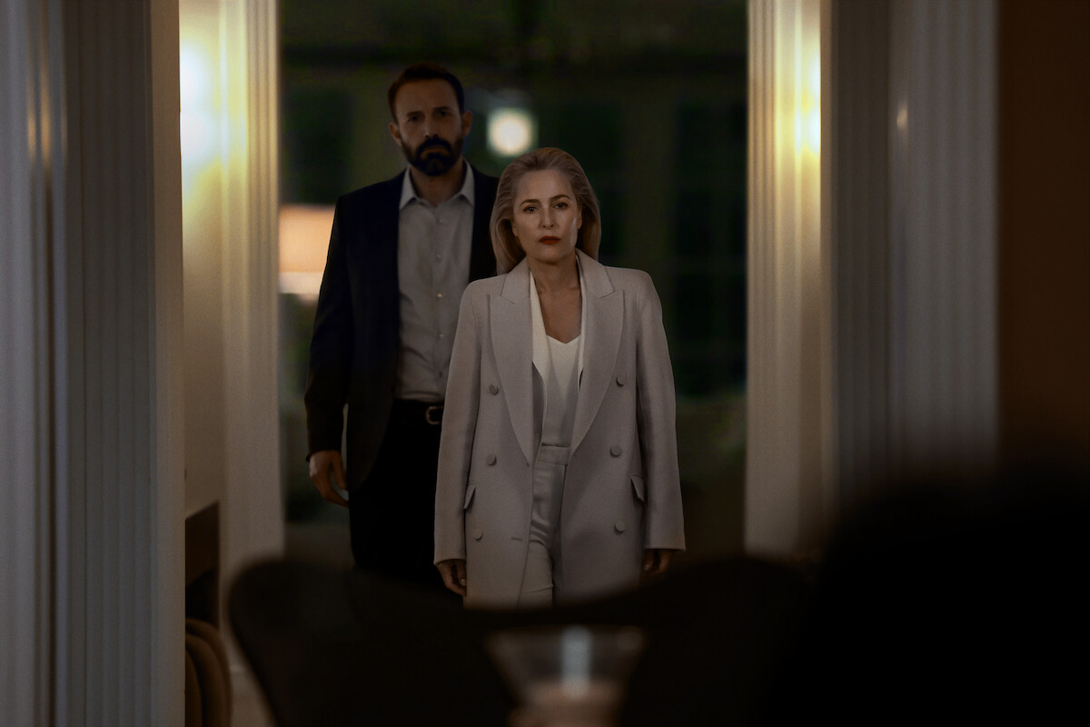 Kerry Washington and Ben Affleck stand in a dim hallway in an official Netflix still from Animals