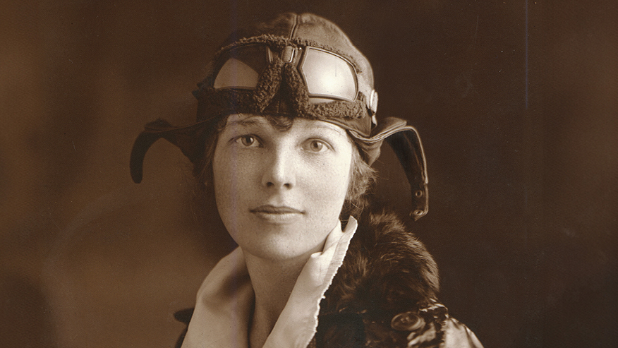 Amelia Earhart in a flying helmet and jacket in a 1922 portrait